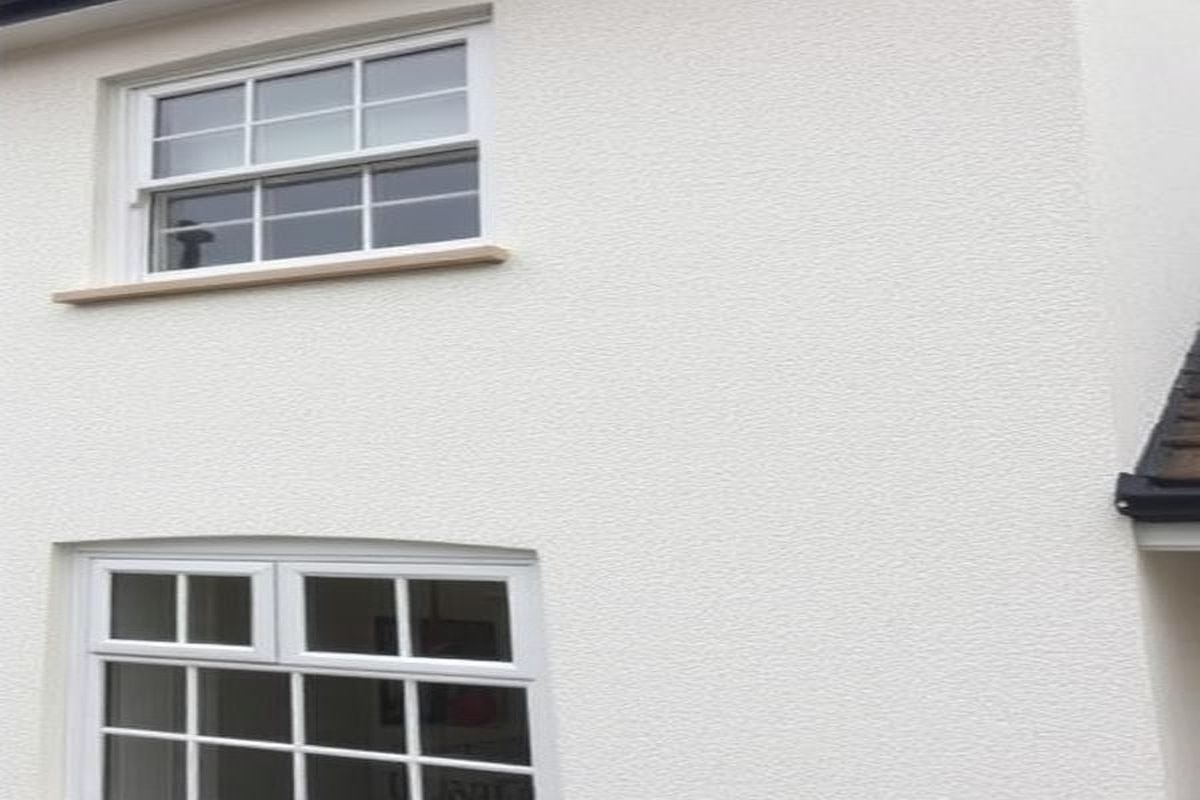 Rendered house facade after low-pressure soft washing